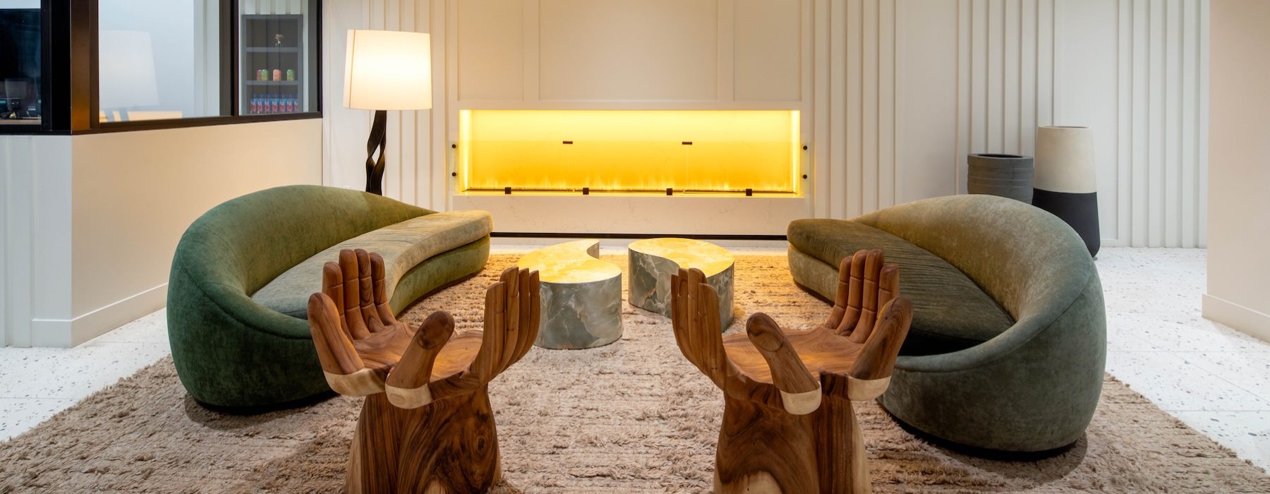 a lounge with seating tables and a fireplace
